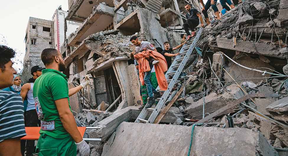 अंतहीन त्रासदीः इजरायली हमले में तबाह हुई आवासीय इमारत के मलबे से एक बच्ची को निकालते फलस्तीन के लोग